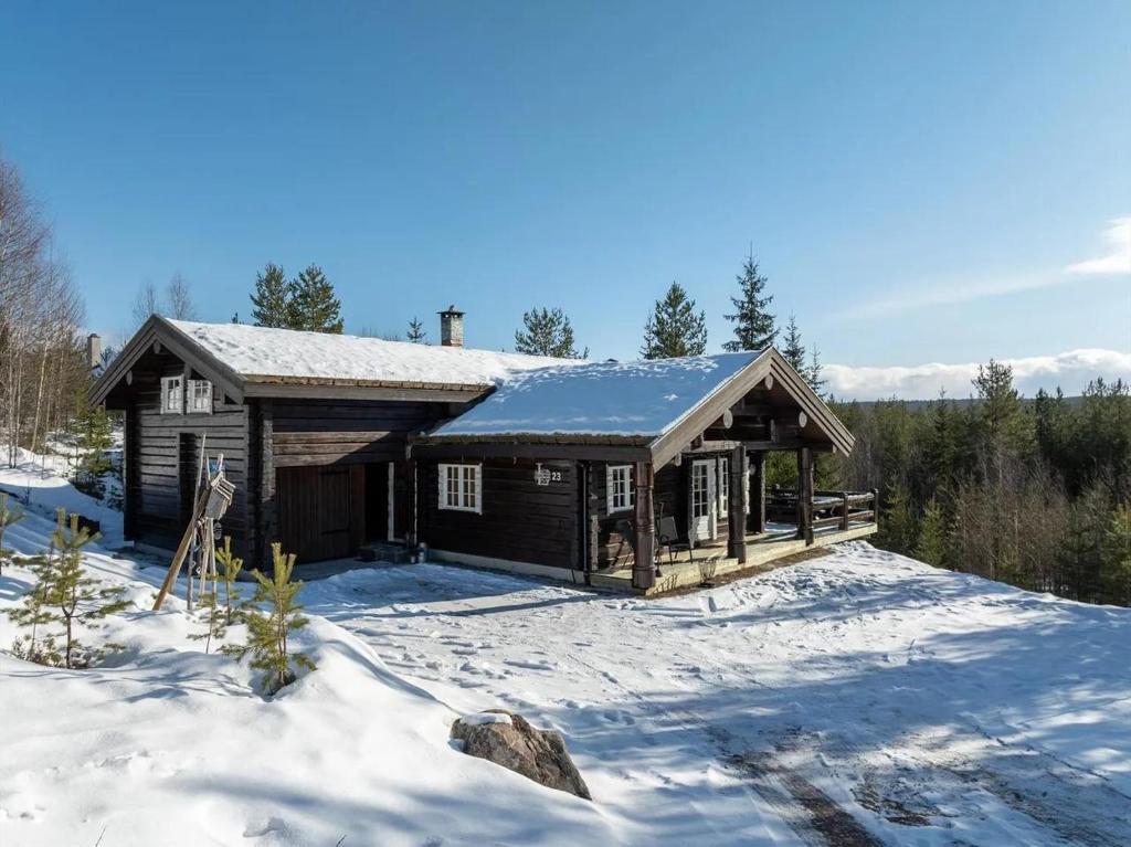a log cabin in the snow with snow at Solskiva 23 in Trysil