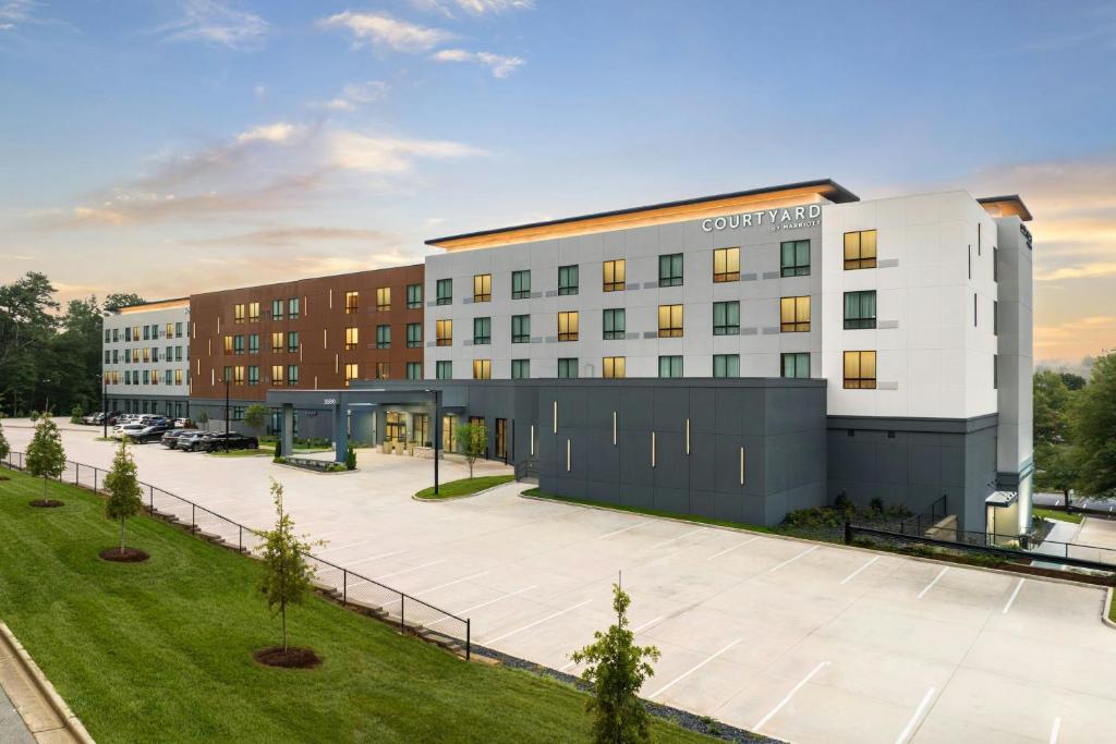 an aerial view of a building with a parking lot at Courtyard by Marriott Birmingham Grandview in Birmingham