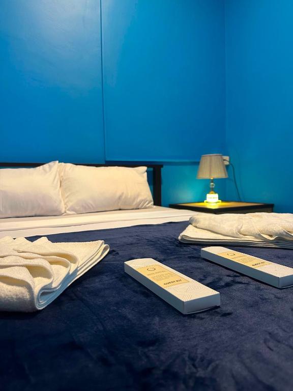 a bed with two thermometers on top of it at SunriseStay in Panglao Island