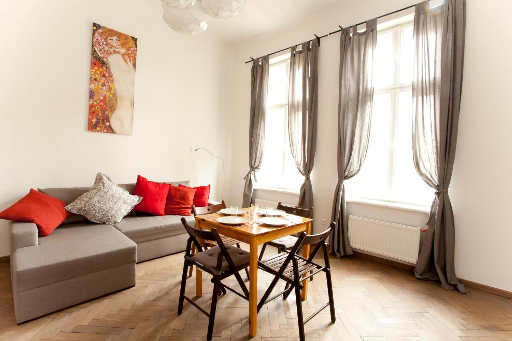 a living room with a table and a couch at Krakow Townhouse in Kraków