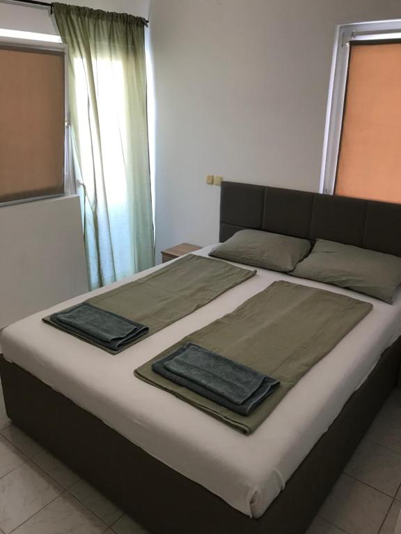 a bed with two pillows on it in a bedroom at Apartments Gumla 1 in Stara Novalja