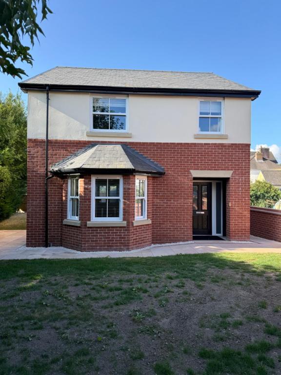 a red brick house with a roof at 25 Birch House in Oswestry