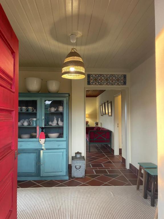 a hallway with a blue cabinet in a house at Casas do Alpendre in Óbidos