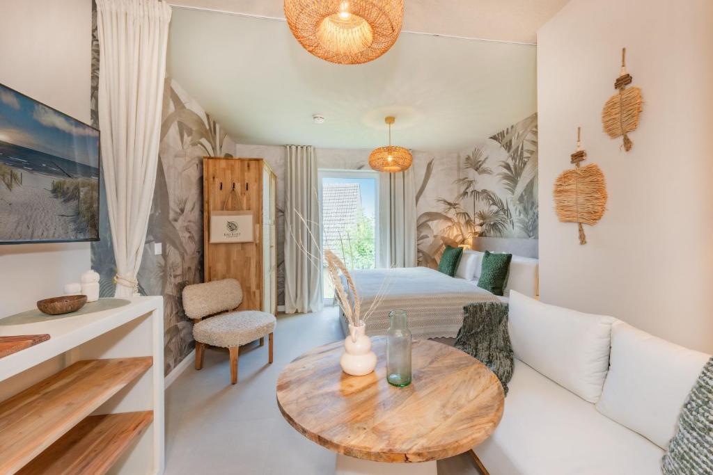 a bedroom with a bed and a table in a room at BALI BLIZZ - App 11 in Benz