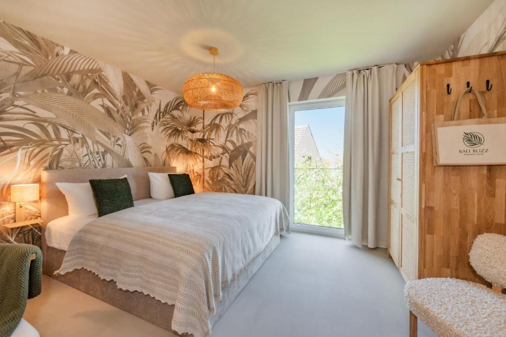 a bedroom with a bed and a large window at BALI BLIZZ - App 12 in Benz
