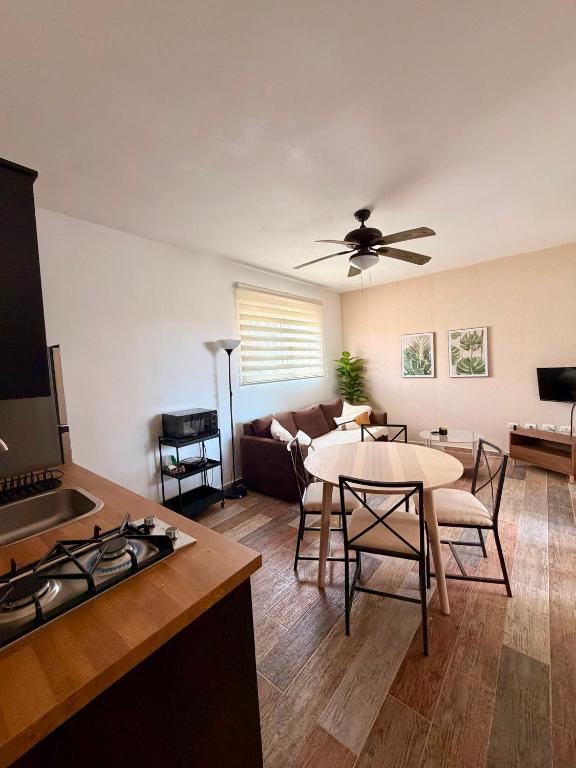 a kitchen and living room with a couch and a table at Vittoria House Garden in Bayahibe