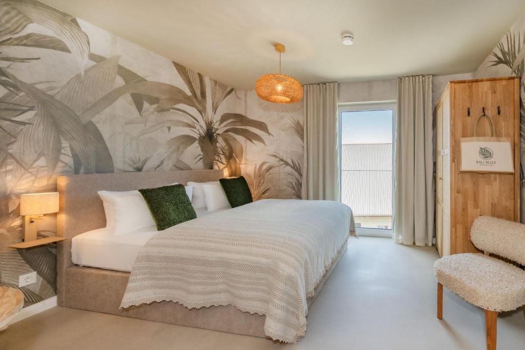 a bedroom with a bed and a palm mural at BALI BLIZZ - App 16 in Benz