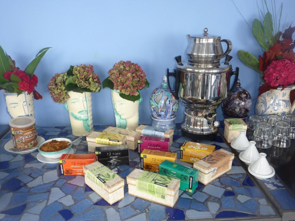 a table topped with vases and a trophy and snacks at Hotel Palladio in Giardini Naxos