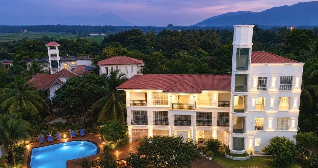 an aerial view of a building and a swimming pool at White Land City Hotel in Dambulla