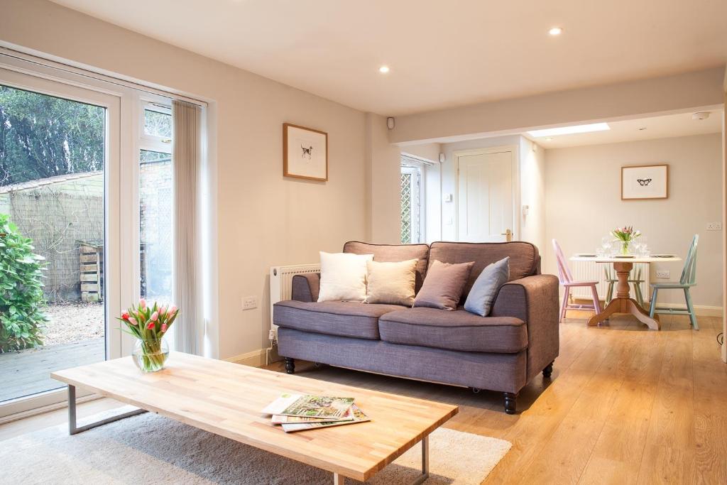 a living room with a couch and a coffee table at Fig Cottage, near Bradford on Avon and Bath in Holt