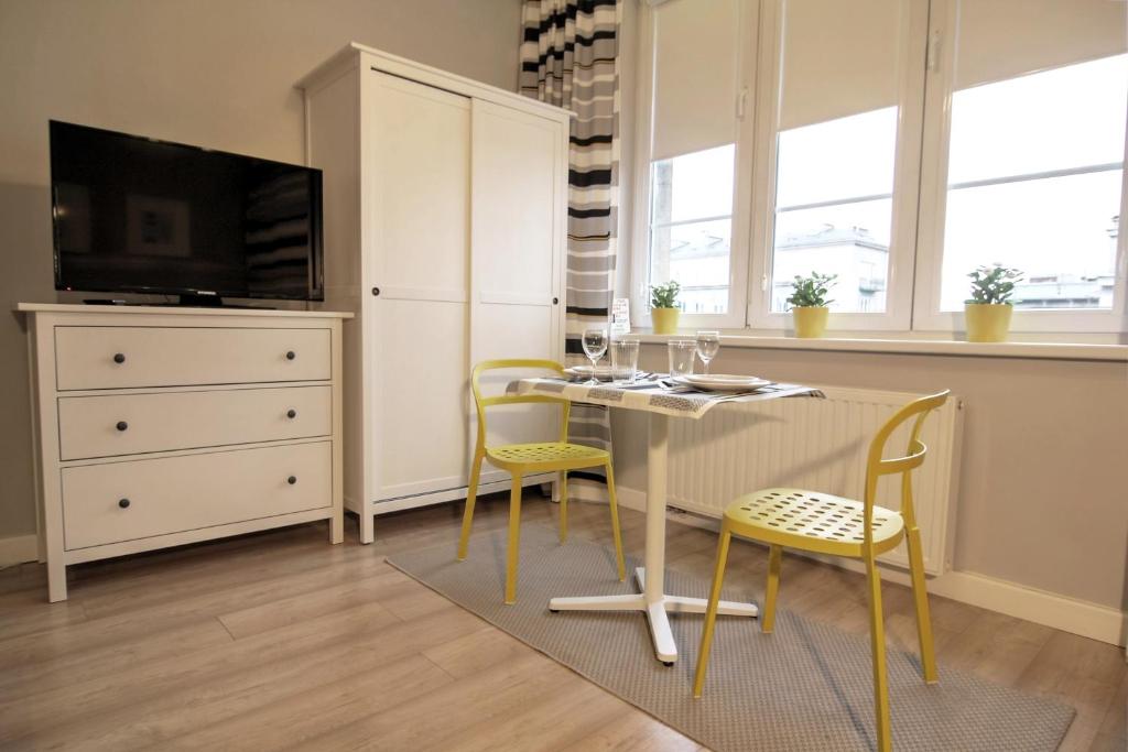 a dining room with a table and two chairs at Apartment I GrayFor2 Old Town Kraków in Krakow
