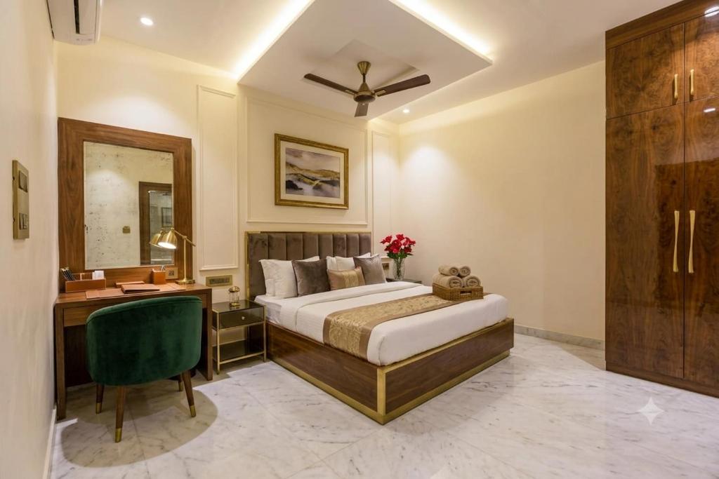 a bedroom with a bed and a desk and a chair at Hotel Grand Heaven in Tājganj