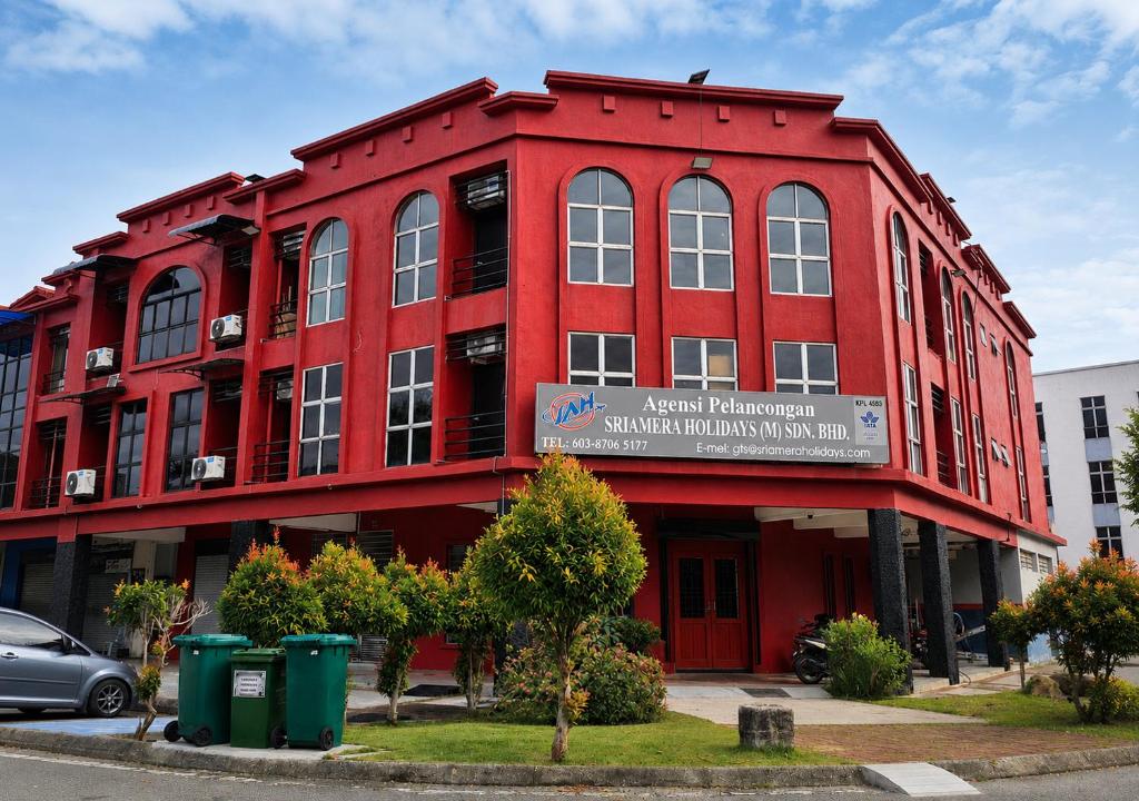 a red building with a sign in front of it at B&B By JumStay in Sepang