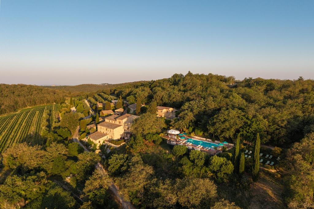 an aerial view of a estate with a swimming pool and trees at Borgo Vescine in Radda in Chianti