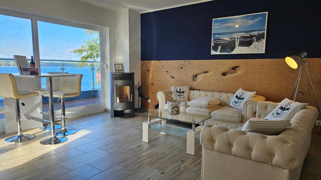 a living room with a couch and a table at Charming Apartments am See in Bad Saarow