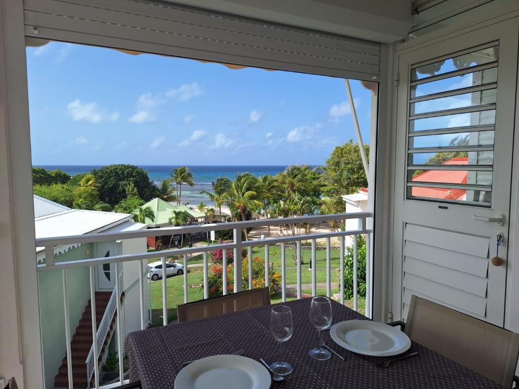 a balcony with a table and a view of the ocean at Studio Alizé 724 in Saint-François