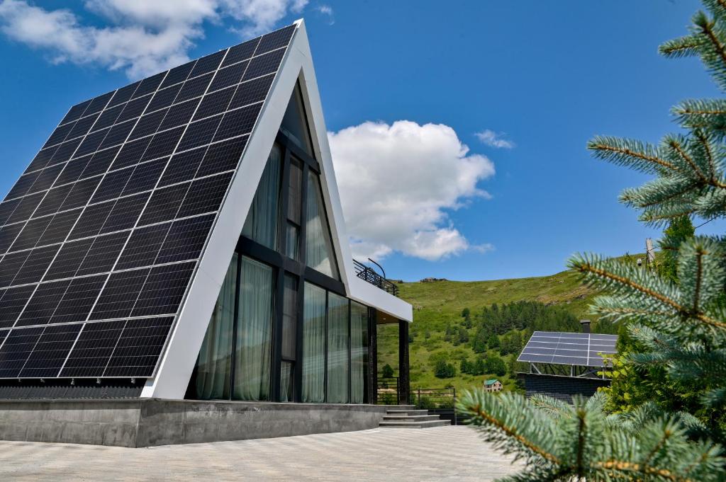 a building with solar panels on the side of it at Sunken Tsaghkadzor in Tsaghkadzor
