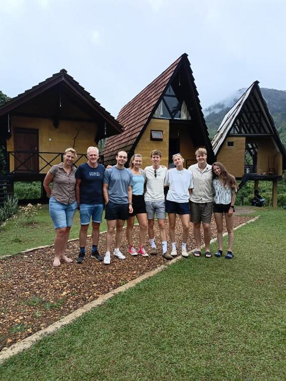 a group of people standing in front of a house at Sinharaja Riverside in Deniyaya
