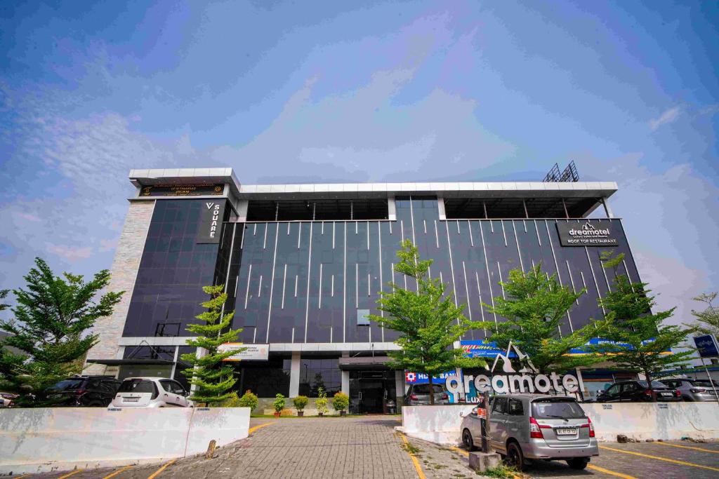 a parking lot in front of a building at Dreamotel Luxury Suites in Kanjikode