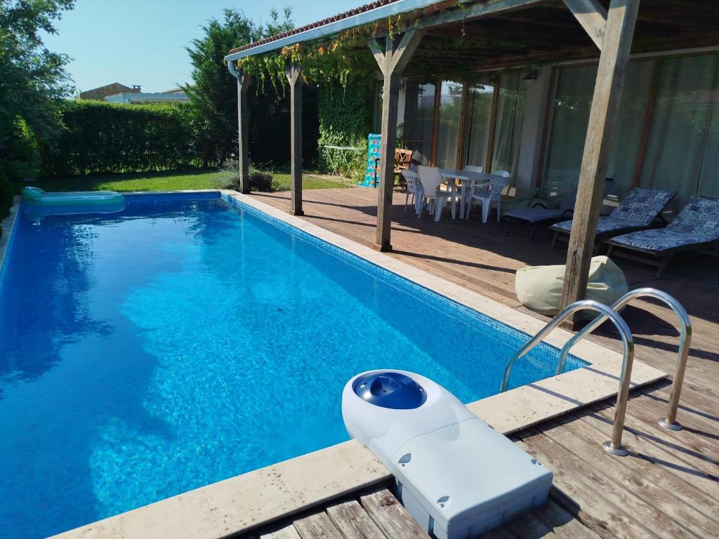 a swimming pool with a white object sitting next to a house at Villa Casablanca with private pool in Lozenets