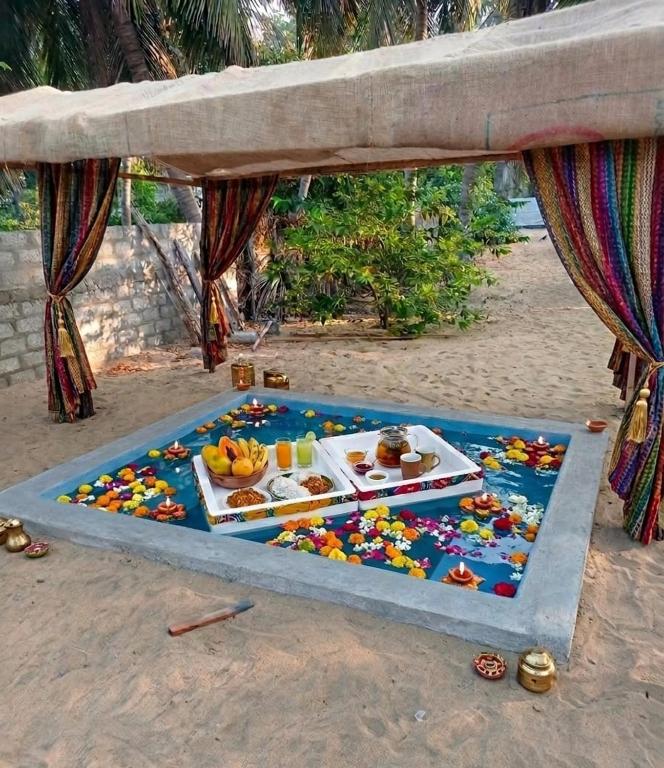 a table with food on it on the beach at FR Resort in Pottuvil