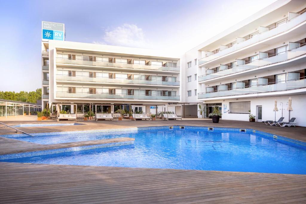 a hotel with a swimming pool in front of a building at RVHotels Nautic Park in Platja d'Aro