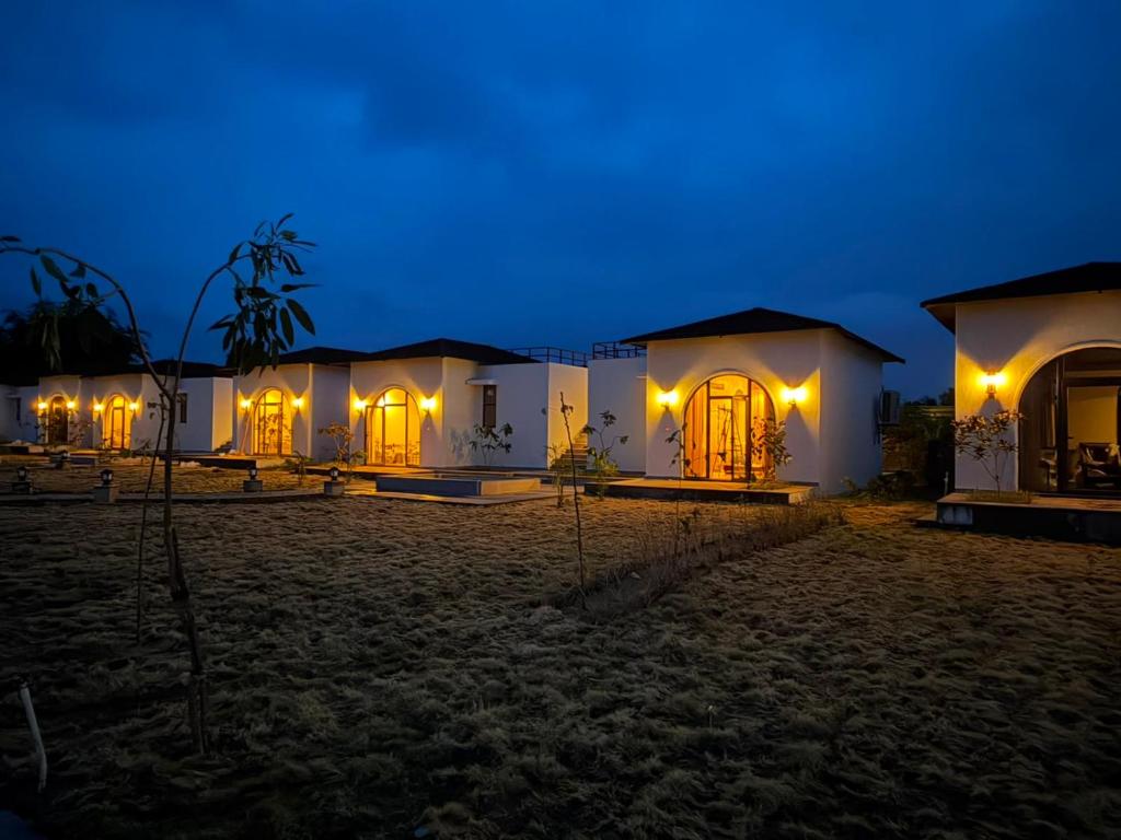 a row of white houses at night at RajVana, Ranthambore in Khilchipur
