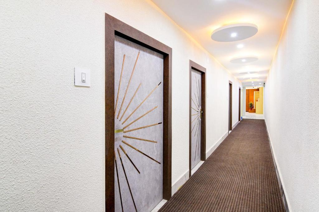 a hallway with a door in a building at Hotel O The Crown in Kolkata