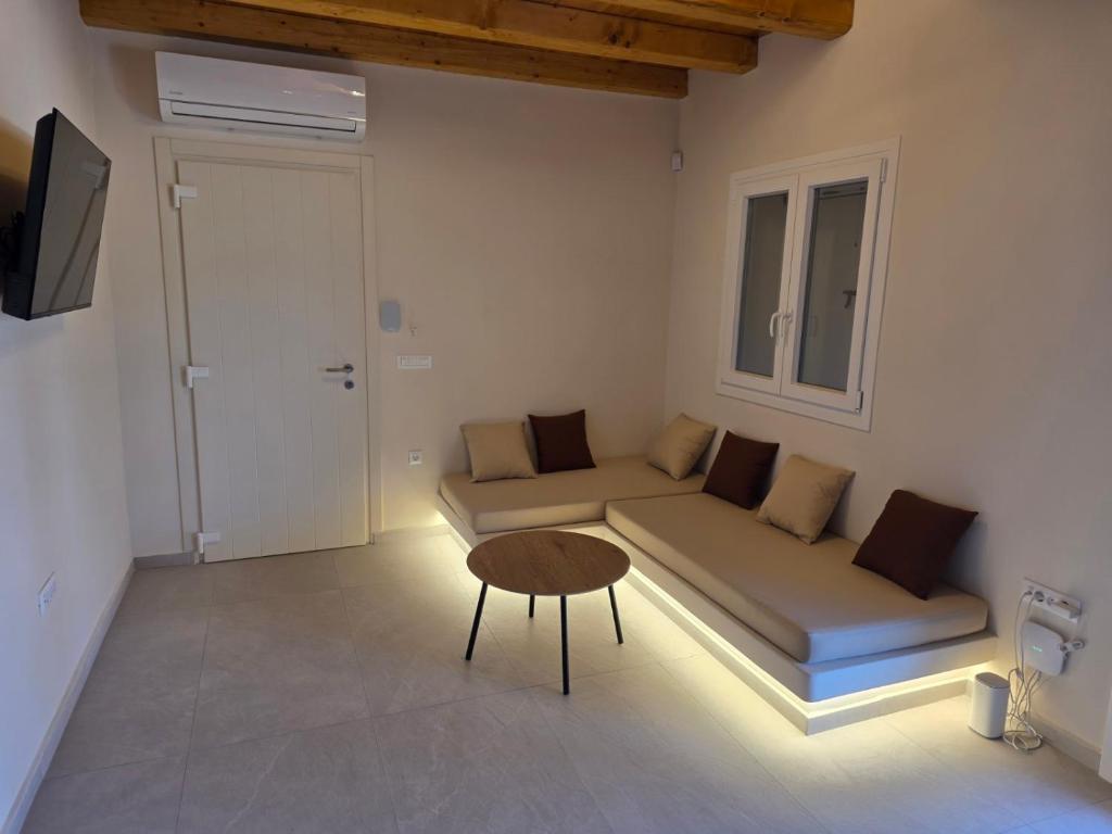 a living room with a couch and a table at Sun & Stones Suite in Agrari