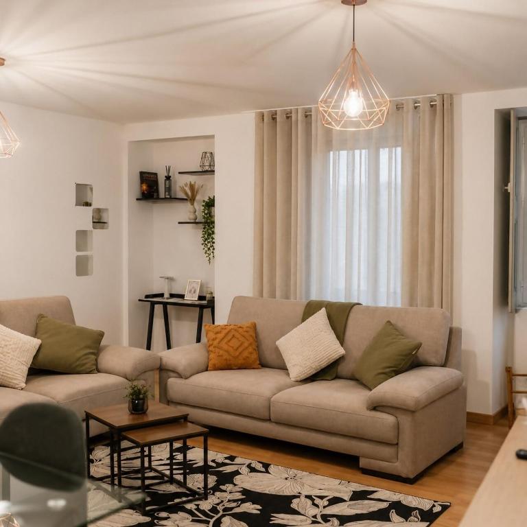 a living room with a couch and a table at Ribeirinha Guesthouse in Guarda