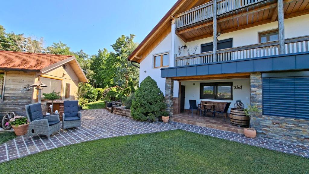 a backyard of a house with a patio at Apartma AURA in Slovenske Konjice