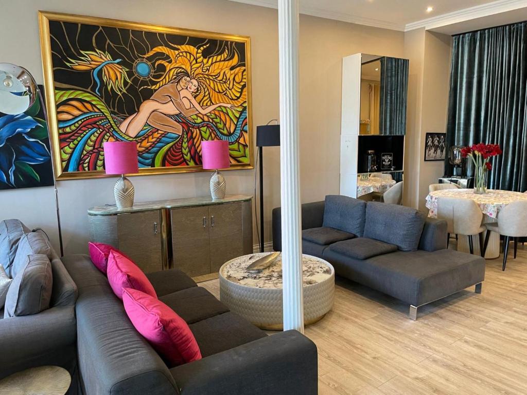 a living room with two couches and a painting at Modern Suite in the Taunus in Bad Camberg