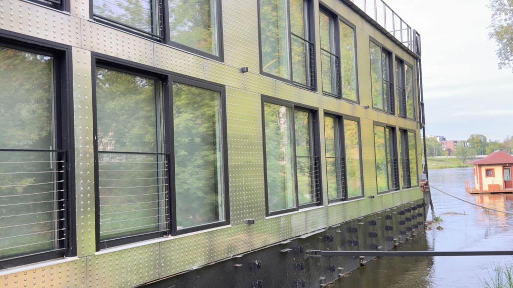 a building with windows on a flooded street at Floatel Vilnius in Vilnius