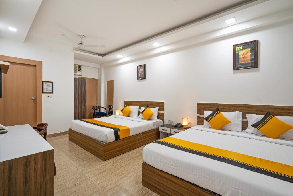 a hotel room with two beds in a room at Itsy Hotels Riya Near IGI Airport in New Delhi