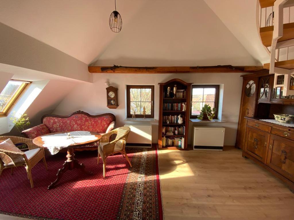 a living room with a red couch and a table at Apartment with a view in Upflamör in Zwiefalten