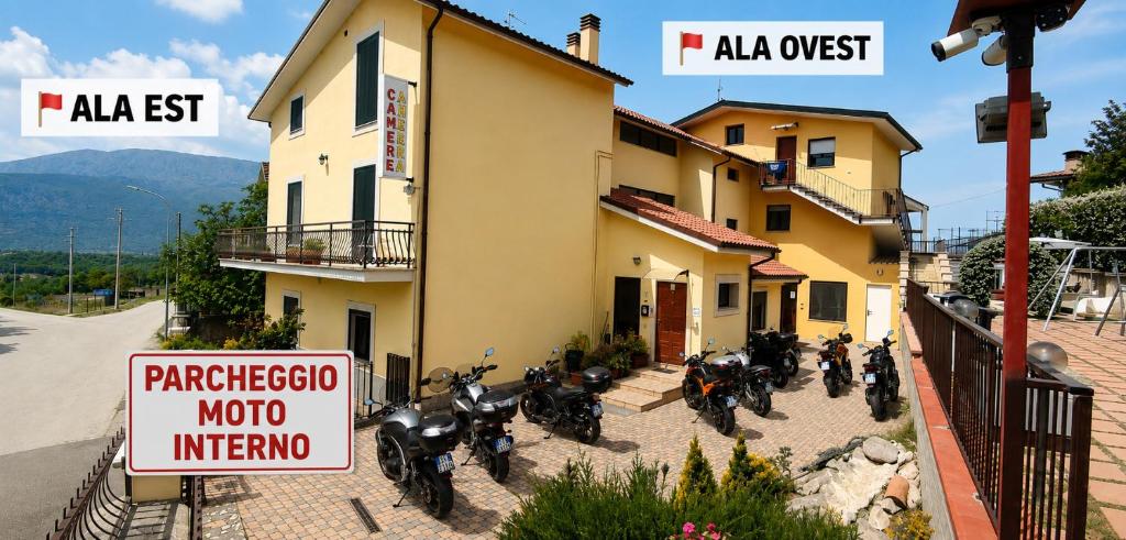 a group of motorcycles parked outside of a building at Complesso Turistico Aurora - camere & Appartamenti in Poggio Picenze