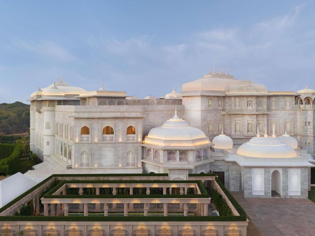 a large white building with domes on top of it at Raffles Jaipur in Jaipur
