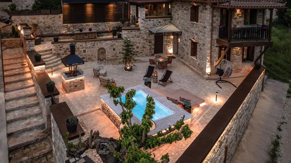 an aerial view of a house with a swimming pool at La Villa de Madeleine - Stone Villa with outdoor hot tub in Arcadia, Peloponnese in Áyios Ioánnis