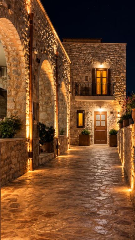 a stone building with a door at night at Lidori Mani in Akhíllion