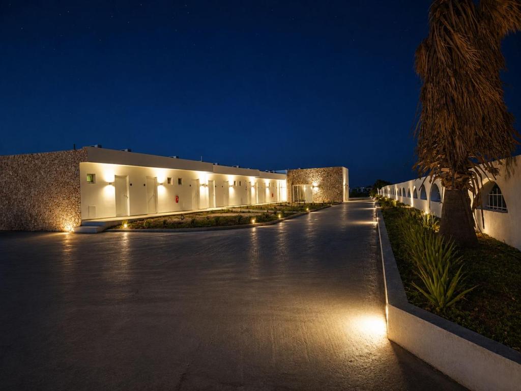 a building with lights on the side of it at night at Evita Flamingo in Kos
