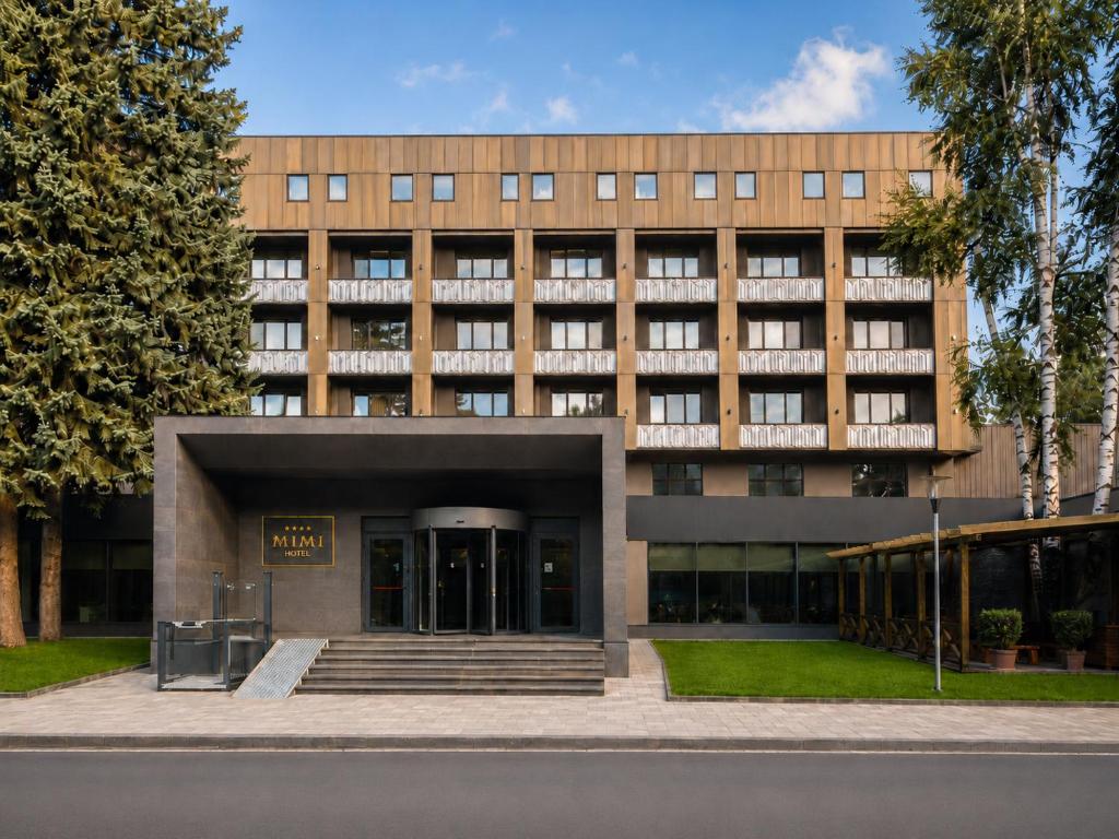 a largeartment building with a staircase in front of it at Mimi Hotel Chisinau Jolly Alon in Chişinău