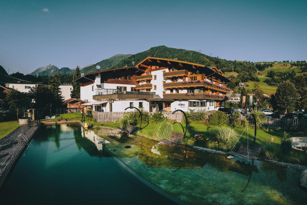 a view of a house next to a body of water at CORE Kaprun in Kaprun