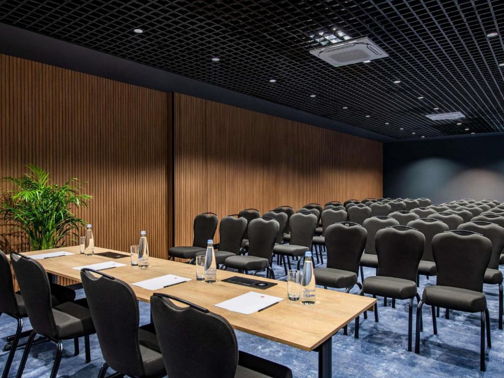 a conference room with rows of tables and chairs at ibis Tbilisi Airport in Tbilisi City