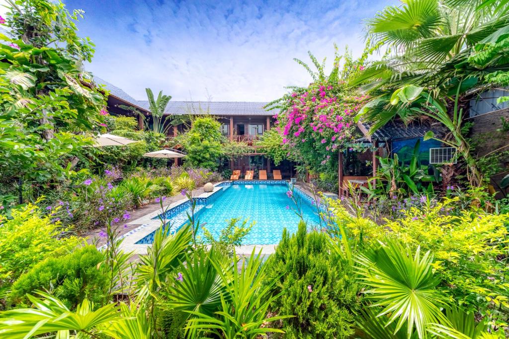 an image of a swimming pool in a garden at Champa Phan Boutique Hotel in Vientiane