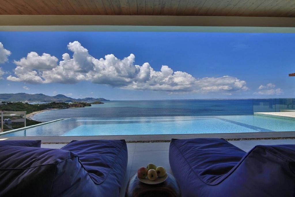 a large window with a view of a swimming pool at Villa with exclusive views in Marigot