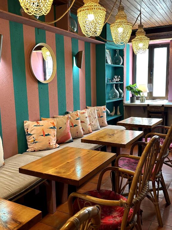 a dining room with wooden tables and chairs at WOT Lodge Soul in Ericeira