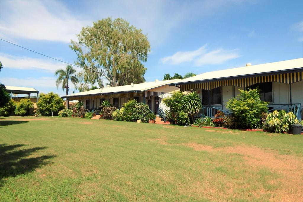 a building with a large yard in front of it at Matildas End Holiday Units in Karumba