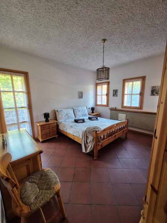 a bedroom with a bed and a table and chairs at Il Posticino del Lago di Como in Esino Lario