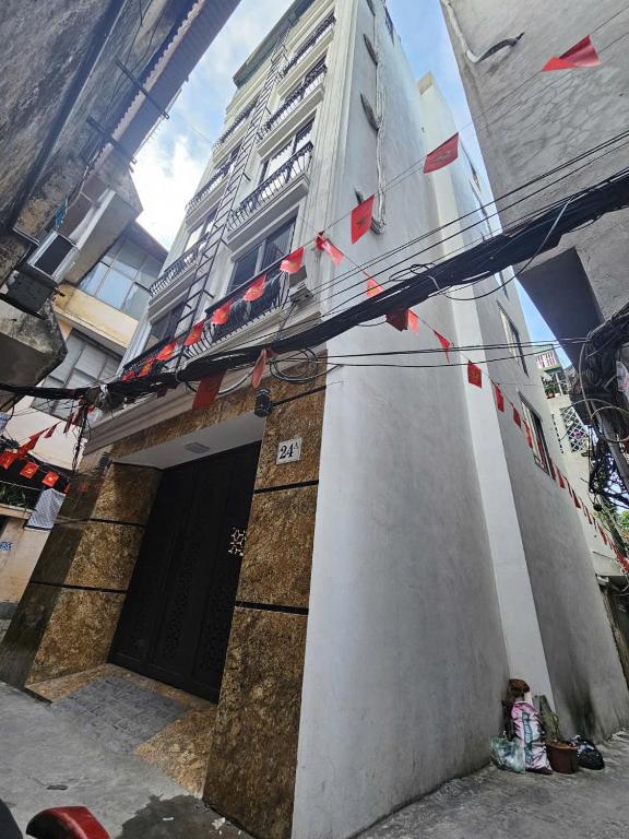 a building with red flags hanging from a building at Khach san Dung Thuy in Bắc Giang