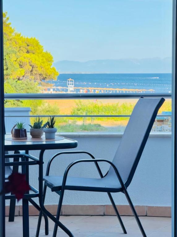 a table and chair on a balcony with a view at Apartments Art in Ulcinj